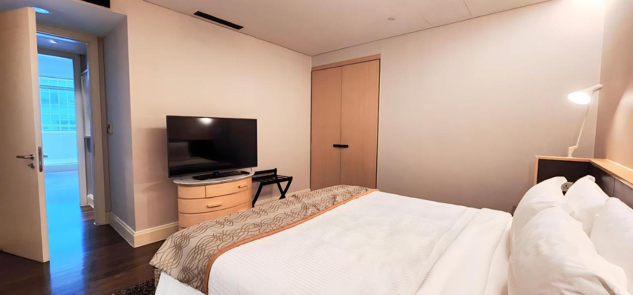 Ascott Raffles Place Singapur Exterior foto A bedroom at the hotel